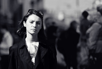 Image showing Young woman among human rush in the city