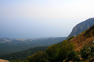 Image showing Top of the mountain with green forest above