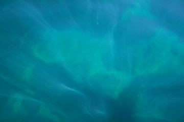 Image showing Rays of light falling into the sea.Close up to the waves surface