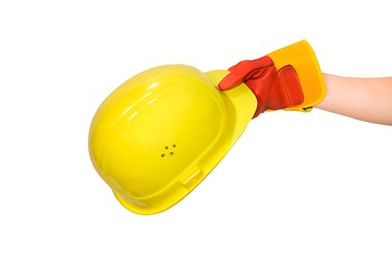 Image showing Hand in glove holding a yellow hard hat isolated
