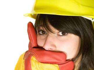 Image showing Girl in yellow hard hat and red gloves get shy isolated