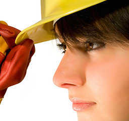 Image showing Girl in yellow hard hat and red gloves