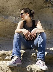 Image showing Model sitting on the rocks. Urban style