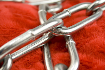 Image showing Steel chain on red fabric