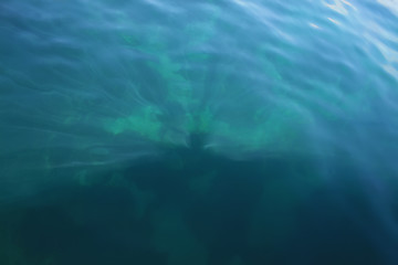 Image showing Rays of light falling into the sea.Close up to the waves surface