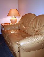 Image showing Leather sofa with lamp on a table