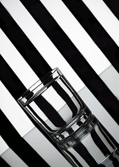 Image showing Glass of water with striped background