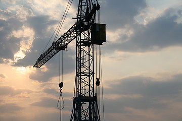 Image showing Construction crane silhouette with cool sunset background