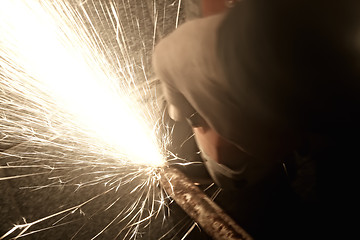 Image showing Sparks from a worker grinding steel