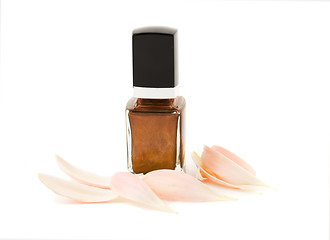 Image showing Nail polish with flower petals isolated