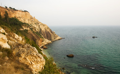 Image showing Sea with rocky beach at sunset