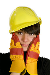 Image showing Girl in yellow hard hat and red gloves