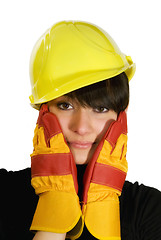 Image showing Girl in yellow hard hat and red gloves