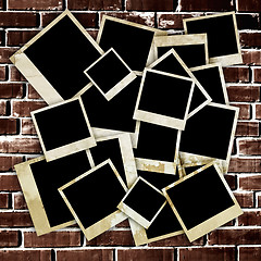 Image showing Empty old photo frames on grunge brick wall background