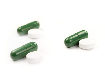 Image showing Green and white pills isolated