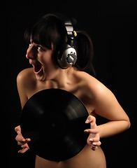 Image showing Naked girl with vinyl plate and headphones