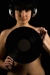 Image showing Naked girl with vinyl plate and headphones