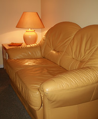 Image showing Leather sofa with lamp on a table