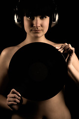 Image showing Naked girl with vinyl plate and headphones