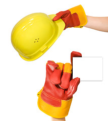 Image showing Red glove holding an empty frame and glove holding a yellow hard