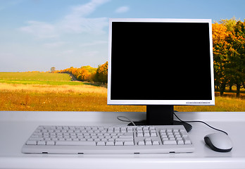 Image showing PC with black desktop and green field background