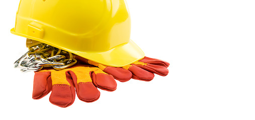 Image showing Yellow hard hat, protective gloves and steel chain isolated
