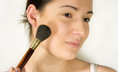 Image showing Girl putting make-up