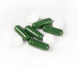 Image showing Green and white pills isolated