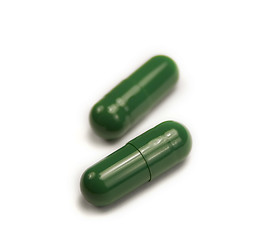 Image showing Two green pills isolated