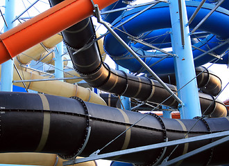 Image showing Twisting, colorful water chutes wind around
