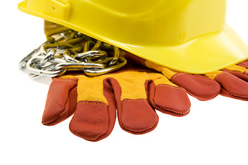 Image showing Yellow hard hat, protective gloves and steel chain isolated