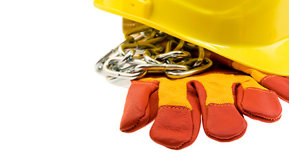 Image showing Yellow hard hat, protective gloves and steel chain isolated