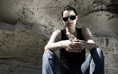 Image showing Model sitting on the rocks. Urban style