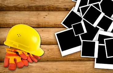 Image showing Yellow hard hat and protective gloves with grunge wall backgroun