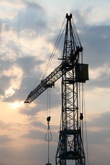 Image showing Construction crane silhouette with cool sunset background