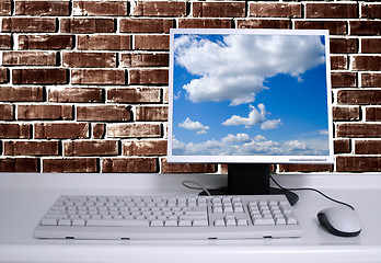 Image showing PC with black desktop and brick wall background and sky desktop