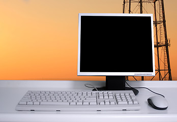 Image showing PC with sunset sky and electric pylons background