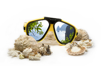 Image showing Yellow diving mask with sea shells and sea rocks reflection