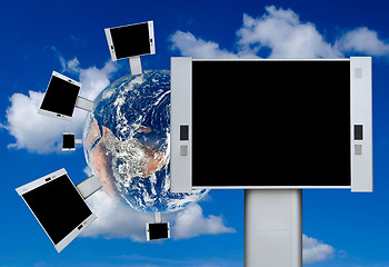 Image showing Blank billboards on the earth with blue sky background