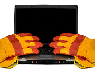 Image showing Protective gloves on a laptop isolated. Empty black desktop for 