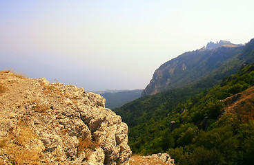 Image showing Top of the mountain with green forest above