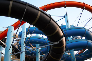 Image showing Twisting, colorful water chutes wind around