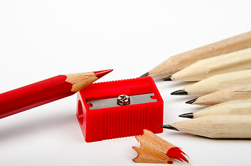 Image showing Group of wooden pencils and red sharpener