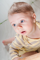 Image showing Little cute baby boy in striped clothes