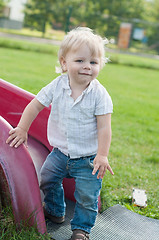 Image showing The little boy standing near children's slides