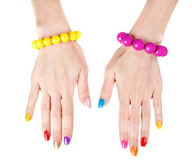 Image showing Women's hands with a fashionable multi-colored nail polish with 