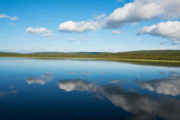 Image showing Calm beautiful rural landscape with a lake and sky reflected