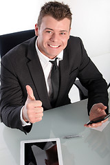 Image showing Enthusiastic young businessman showing thumb up