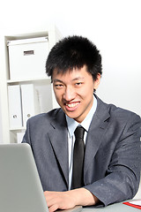 Image showing Asian businessman working on computer