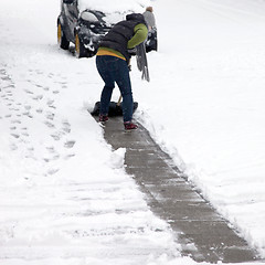 Image showing Person clearing snow off a pathway